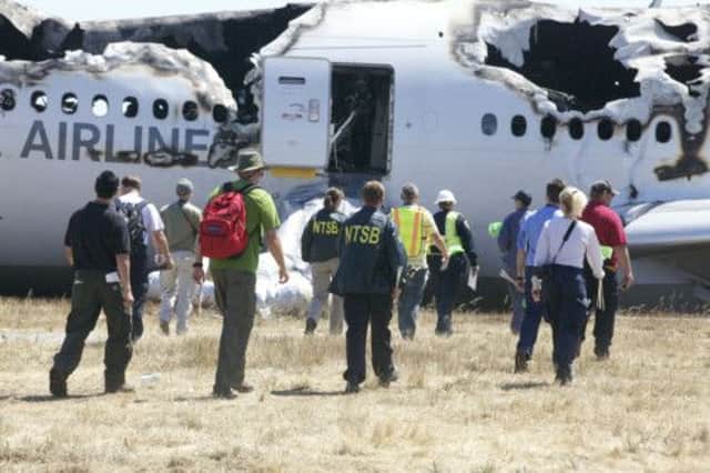 Investigators examine the planes wreckage. Picture: AP