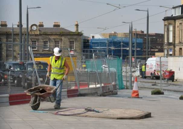 Workers begin to put the memorial back in place. Picture: Phil Wilkinson
