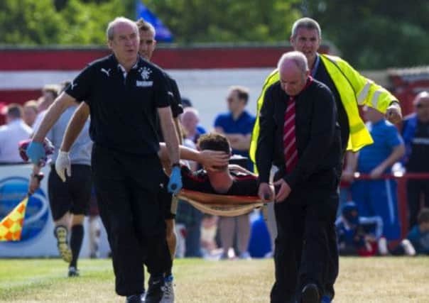 Ross Perry is stretchered off the park after sustaining an injury against Brora Rangers. Picture: SNS