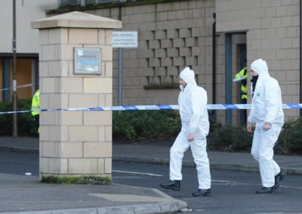 Forensic police workers in Edinburgh's Hawkhill Close, where Dodou Leigh was found murdered. Picture: Neil Hanna