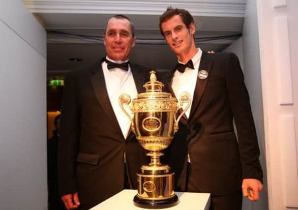 Andy Murray and his coach Ivan Lendl pose with the Wimbledon mens singles trophy. Picture: Getty