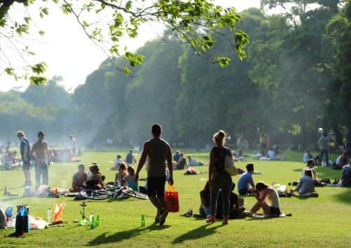 Sun worshippers enjoy the warm weather on Edinburgh's Meadows yesterday. Picture: Ian Rutherford