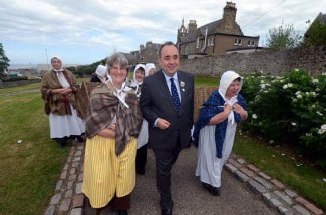 Alex Salmond in Buckie with local ladies dressed as fishwives, where he reopened the historic Fishwives' Path. Picture: Hemedia