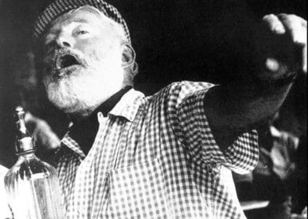 Ernest Hemingway enjoys himself at a bar in Pamplona, Spain. Picture: AP