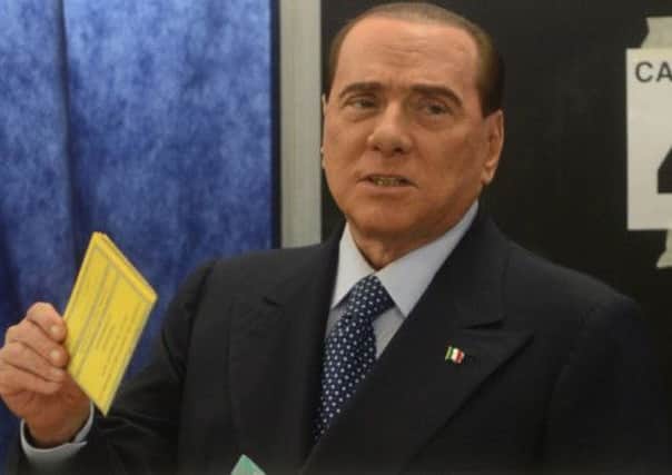 Former Italian Prime Minister Silvio Berlusconi casts his ballot in February's elections. Picture: AFP/Getty