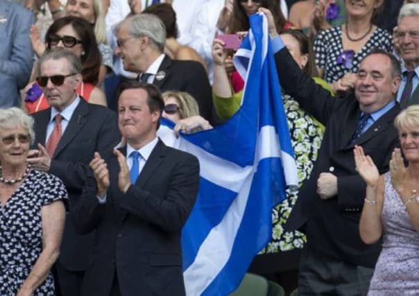 First Minister of Scotland Alex Salmond celebrates with a Saltire after Andy Murray's victory in the Wimbledon final. Picture: SNS