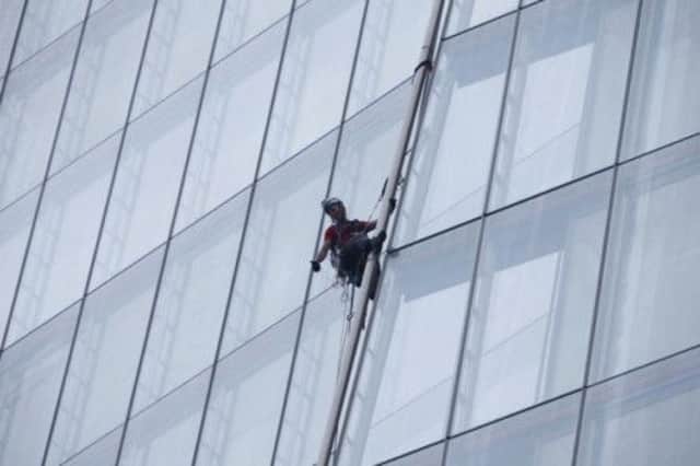 Liesbeth Debbens gestures during her ascent of "The Shard". Picture: Contributed