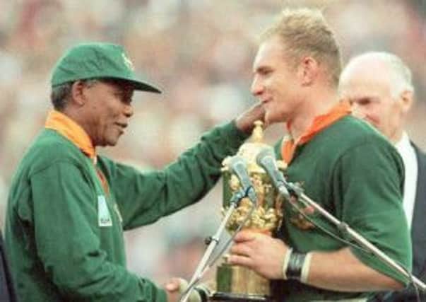 Nelson Mandela congratulates Francois Pienaar after handing him the Rugby World Cup trophy in 1995. Picture: AFP/Getty