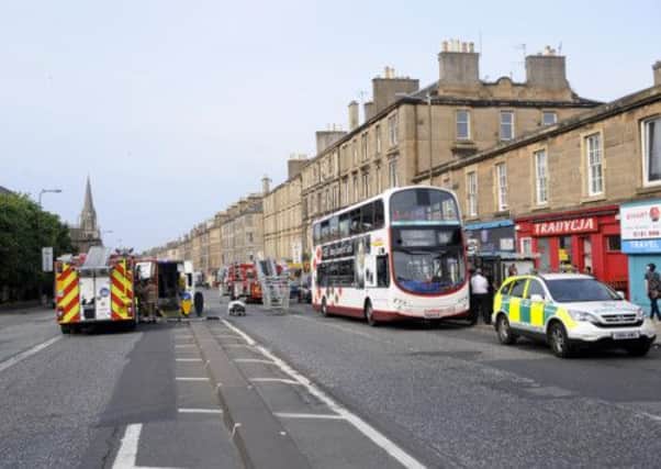 Paramedics attend the scene on Leith Walk. Picture: Greg Macvean