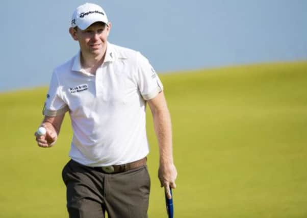 Scotland's Stephen Gallacher collects his ball after putting on the 12th green. Picture: SNS