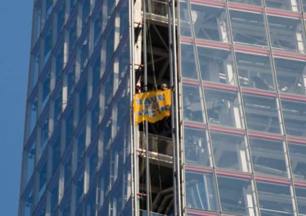 A member of Greenpeace displays a banner which reads 'Save The Arctic'. Picture: Getty