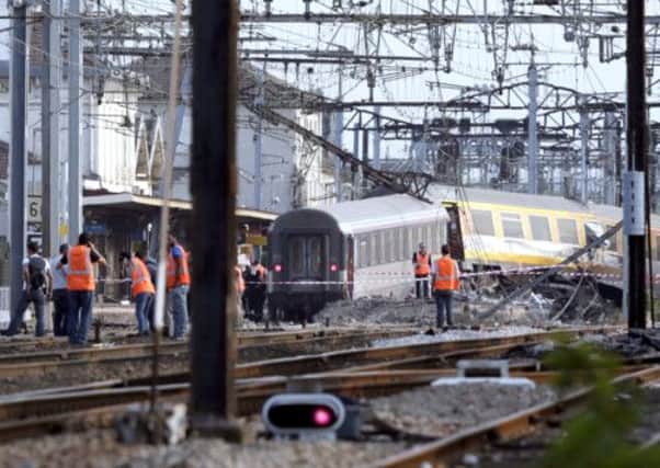 Rescuers work on the site of a train accident in the railway station of Bretigny-sur-Orge. Picture: AFP/ Getty