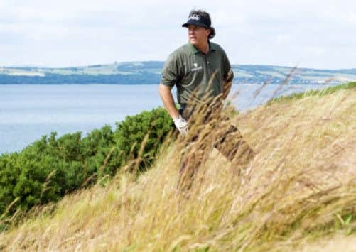 America's Phil Mickelson weighs up his options as he prepares to play out of the rough. Picture: SNS
