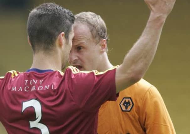 Wolves Leigh Griffiths gets close and personal with the Lions defender Jason Talbot. Picture: Toby Williams