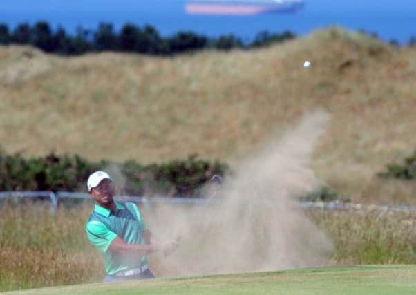 Tiger Woods, who landed at Edinburgh Airport at 8am yesterday, takes aim from a greenside bunker. Picture: Ian Rutherford