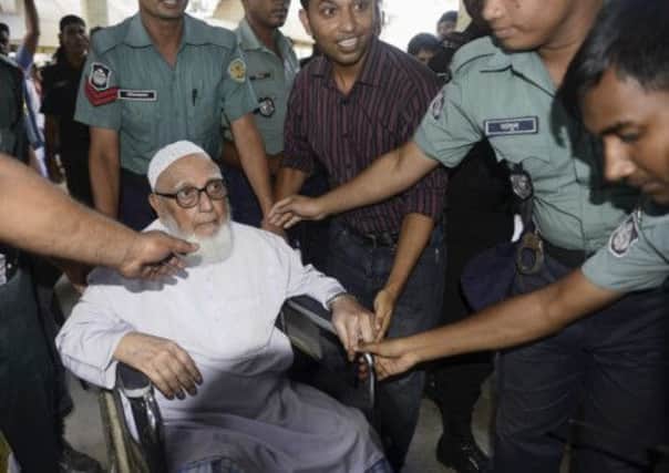 Ghulam Azam, former head of the Jamaat-e-Islami party, exits a court after the verdict of his trial in Dhaka. Picture: Reuters