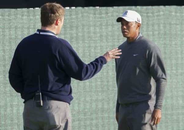 Tiger Woods is ushered off the course after starting his practice earlier than was permitted. Picture: SNS