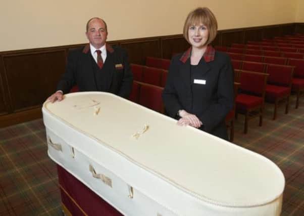 Staff at John Fraser & Son display one of the wool coffins. Picture: John Fraser/johnfraserandson.com