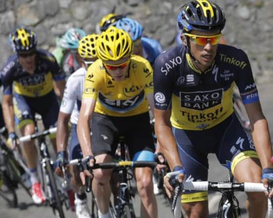 Chris Froome, left, almost came to grief after a risky manoeuvre by Alberto Contador, right.  Picture: Christophe Ena/AP