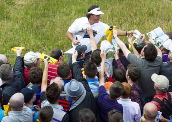 Ae media scrum greeted Phil Mickelson, pictured signing autographs for fans on the course. Picture: SNS