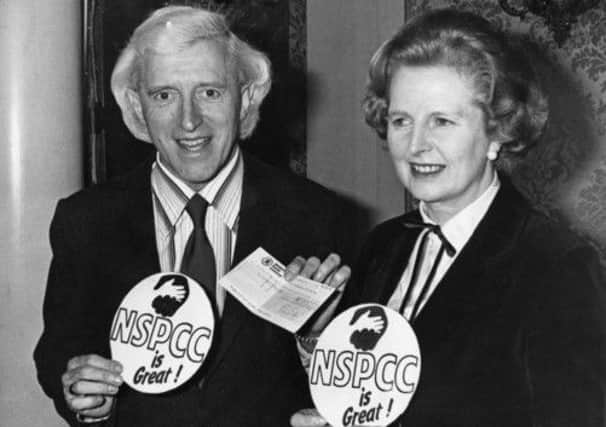 Margaret Thatcher, seen here at a charity fundraising event with Jimmy Savile, wanted him to receive a knighthood. Picture: Getty