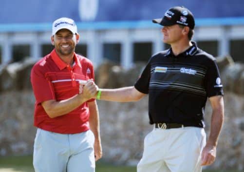 Paul Lawrie shakes hands with Sergio Garcia during practice at Muirfield yesterday. Picture: Jane Barlow