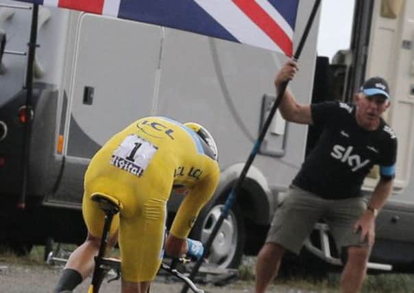 Chris Froome is cheered on by a flagwaving British supporter during yesterdays 17th stage of the Tour de France. Picture: AP