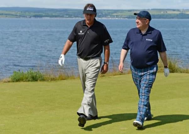 Alex Salmond chats to Phil Mickelson during a round at Castle Stuart. Picture: Getty
