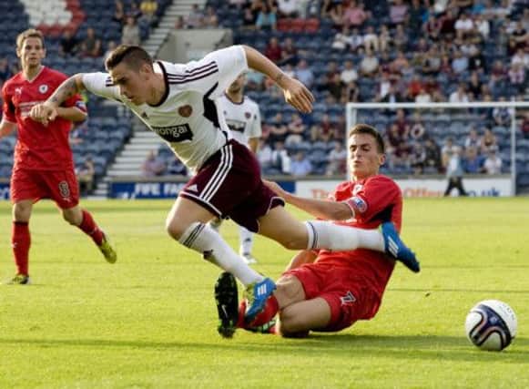 Jamie Walker of Hearts is tackled by Raith Rovers Grant Anderson during last nights friendly encounter at Starks Park. Picture: SNS