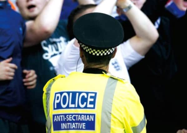 A police officer keeps an eye on the crowd during an Old Firm match at Hampden. Picture: SNS