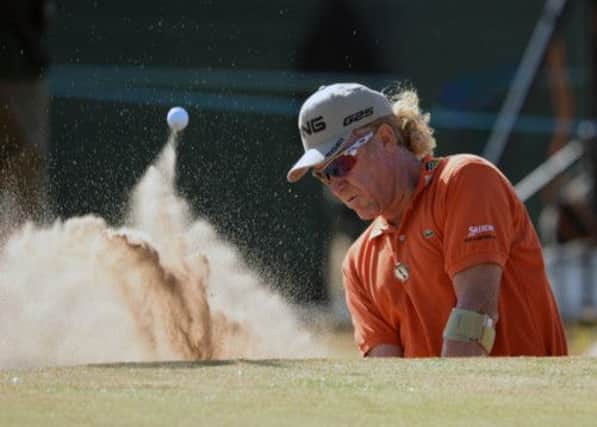 Miguel Angel Jimenez plays out of a greenside bunker at the 18th on his way to taking the overnight lead at Muirfield yesterday. Picture: Ian Rutherford
