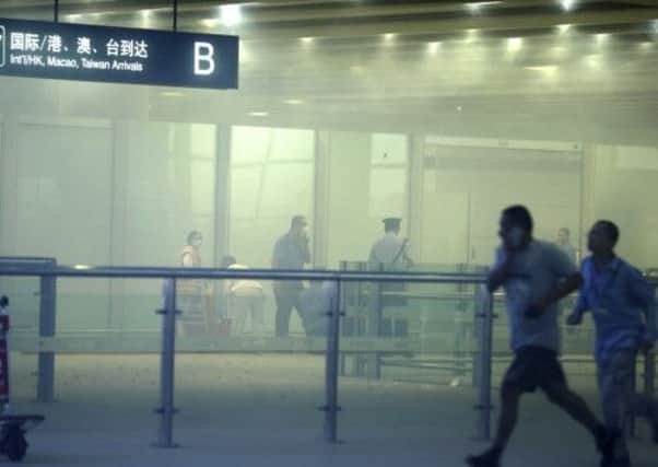 Medical workers and policemen at the terminal 3 of the Beijing International Airport after the blast. Picture: AP/Xinhua