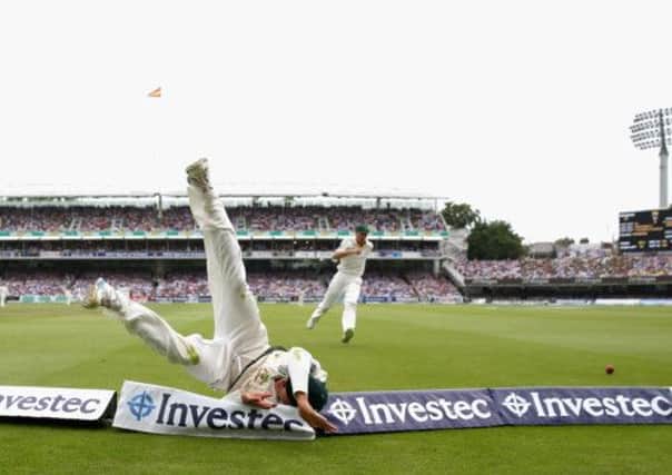 Australia's Usman Khawaja dives to save a boundary as England piled up the runs at Lords yesterday. Picture: Getty