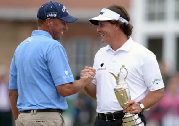 Phil Mickelson shakes hands with caddie Jim Bones McKay. Picture: Ian Rutherford