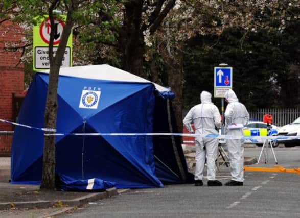Police forensic officers examine the scene in where Mr Saleem was killed as he returned home from a mosque. Picture:PA