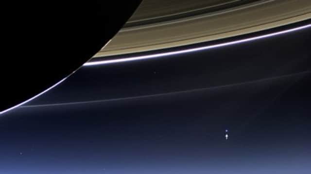 The Earth and the moon, seen in the bottom-right hand corner, captured by the Cassini space probe. Picture: NASA