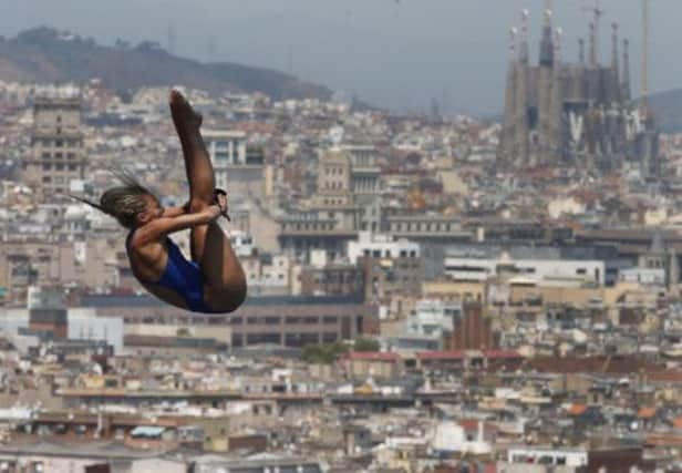 Against a stunning Barcelona backdrop, Tonia Couch makes a dive in the ten-metre semi-final. Picture: AP