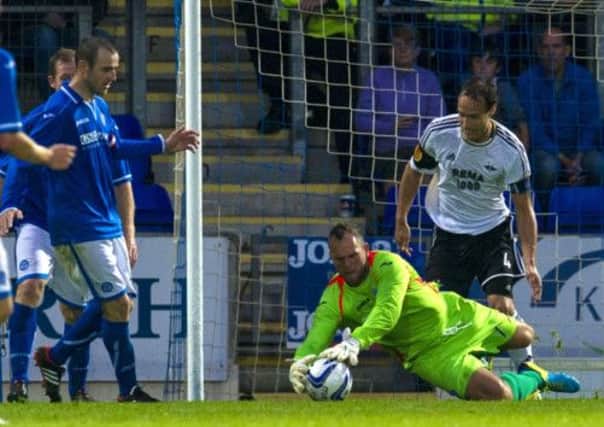 Alan Mannus smothers the ball to thwart another Rosenborg attack. Picture: SNS