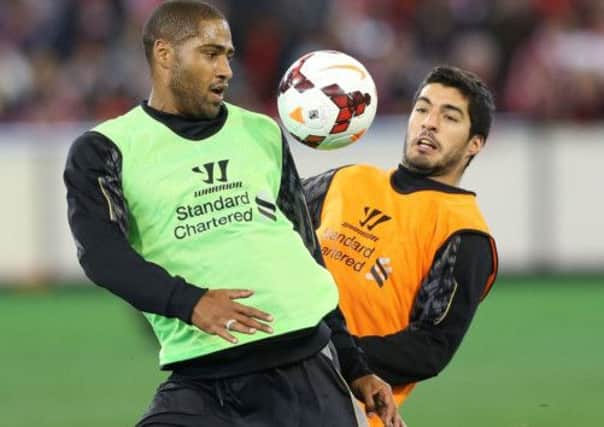 Glen Johnson, left, and Luis Suarez in training this week. Liverpool have rejected two Arsenal bids for the striker. Picture: Getty