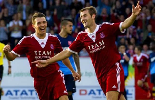 Niall McGinn (right) is congratulated by Ryan Jack after putting his side ahead. Picture: SNS