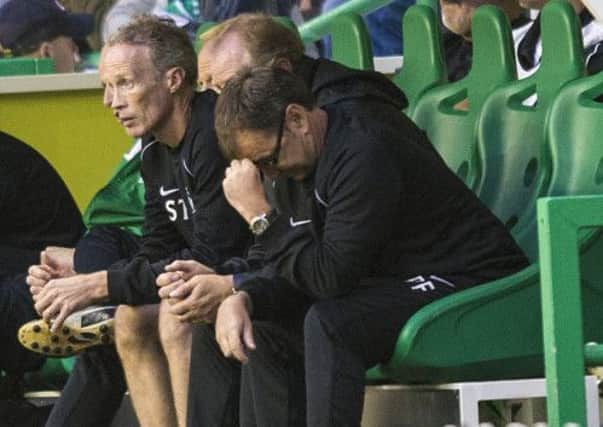Pat Fenlon can't watch as his Hibs side are crushed by Malmo. Picture: SNS