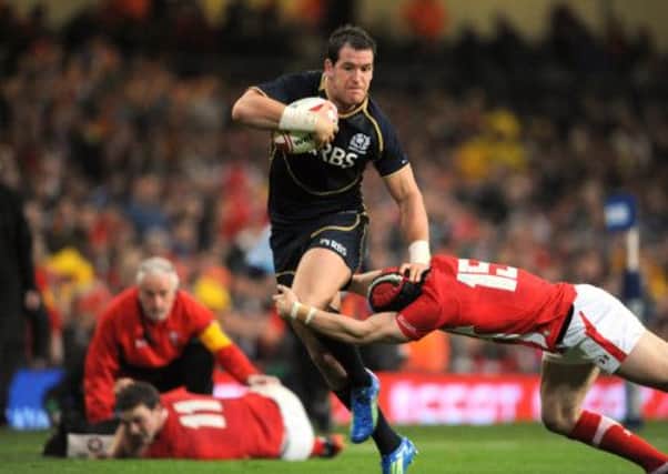 Rory Lamont takes on Leigh Halfpenny, while George North receives treatment, in Scotland's 2012 6 Nations game with Wales. Picture: Jane Barlow