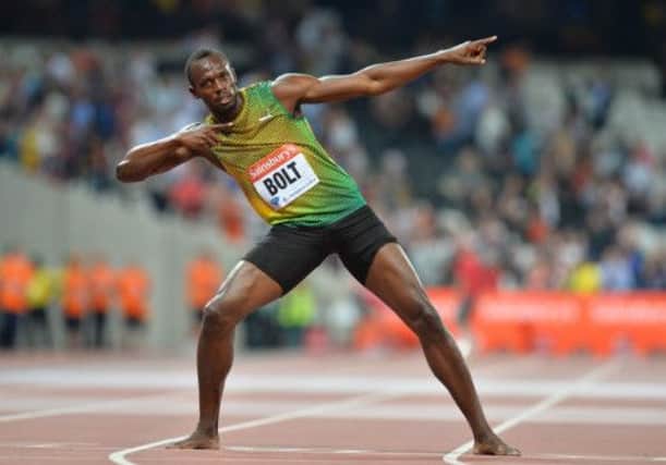 Usain Bolt plays to the crowd with his trademark 'lightning bolt' celebration after his 100m victory. Picture: Getty