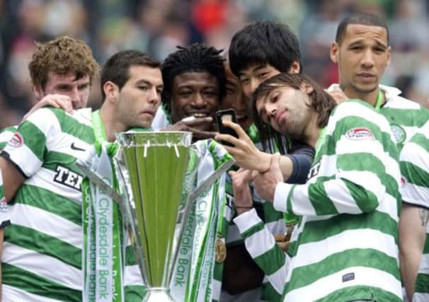 Mo Bangura, centre, celebrates winning the SPL title with his team-mates in 2012. Picture: SNS