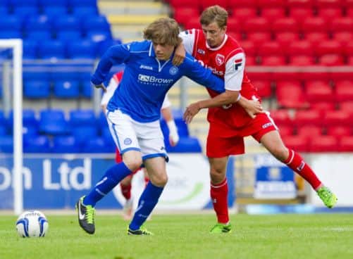 Murray Davidson holds off Morecambes Andrew Fleming in his first game since re-signing for Saints. Picture: SNS