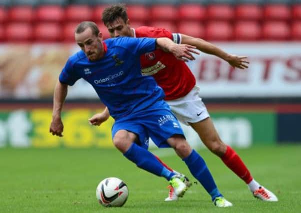 Inverness new boy James Vincent tries to evade the shackles of Charltons Johnnie Jackson at The Valley. Picture: Getty