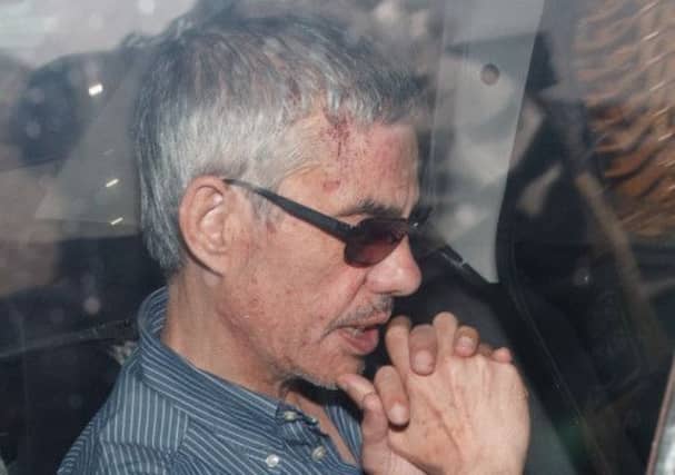 Train driver Franciso Garzon en route to the hearing yesterday, in handcuffs in a police car. Picture: Getty