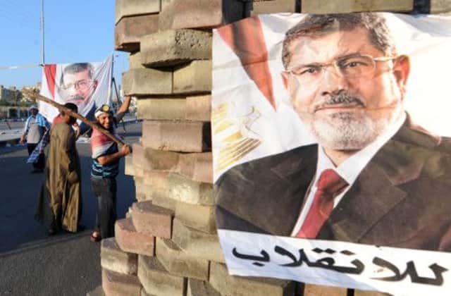 An image of deposed president Mohamed Morsi adorns a brick barricade in an eastern suburb of Cairo. Picture: AFP/Getty Images