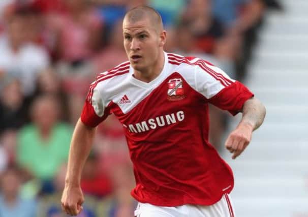 James Collins in action for Swindon. The striker is aiming to make a big impact at Hibs. Picture: Getty
