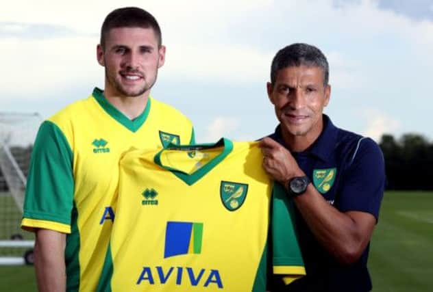 Former Celtic striker Gary Hooper is welcomed to Norwich City by his new manager Chris Hughton yesterday. Picture: PA